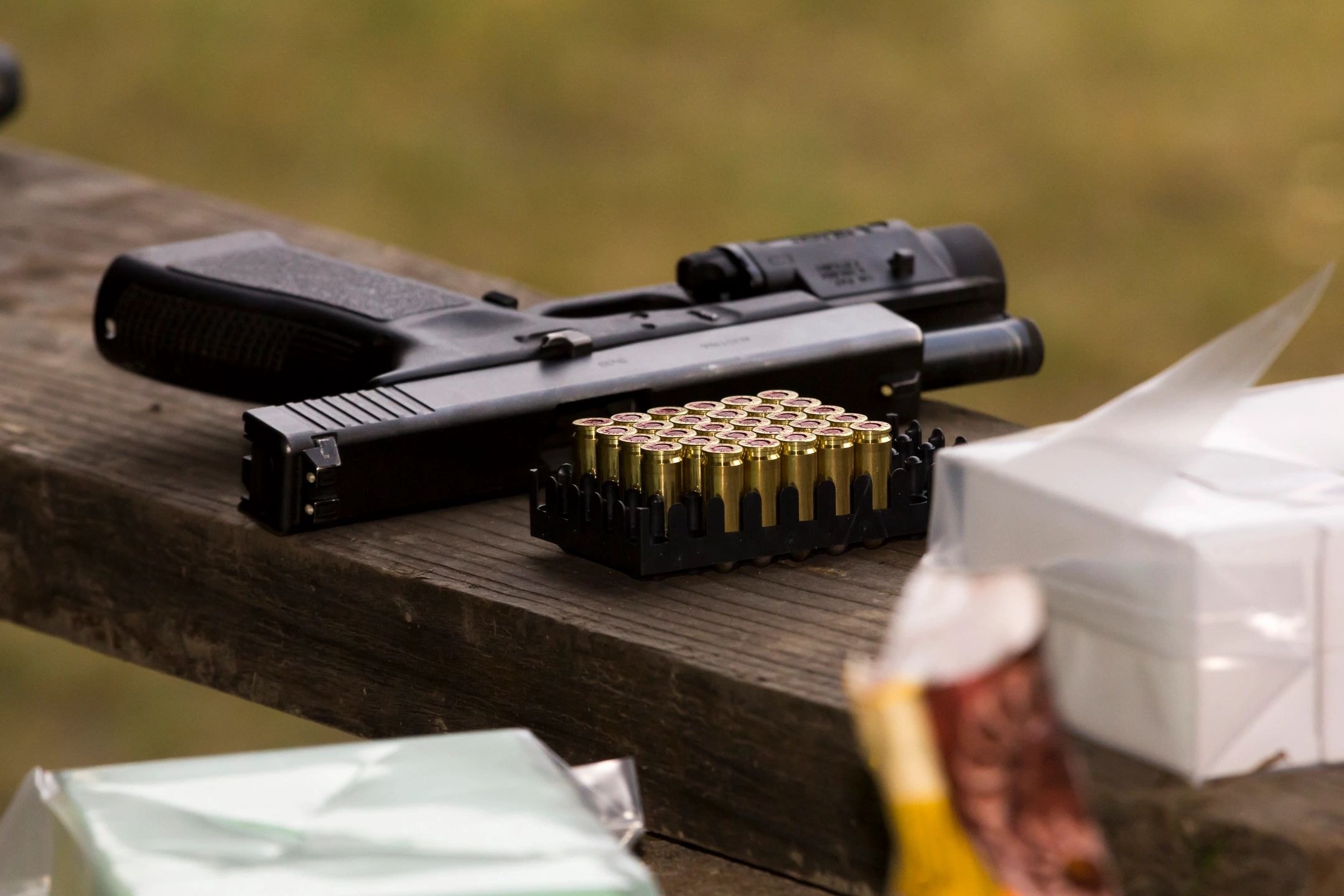 Handgun on wooden surface with ammunition magazine
